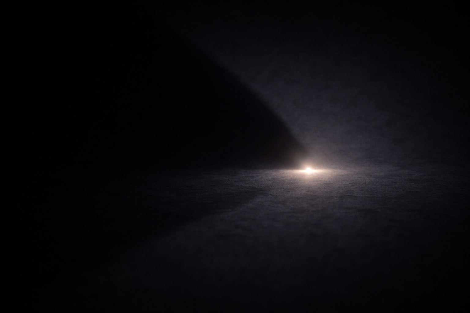 中央の小さな光を覆う大きな影が支配を象徴する抽象イメージ